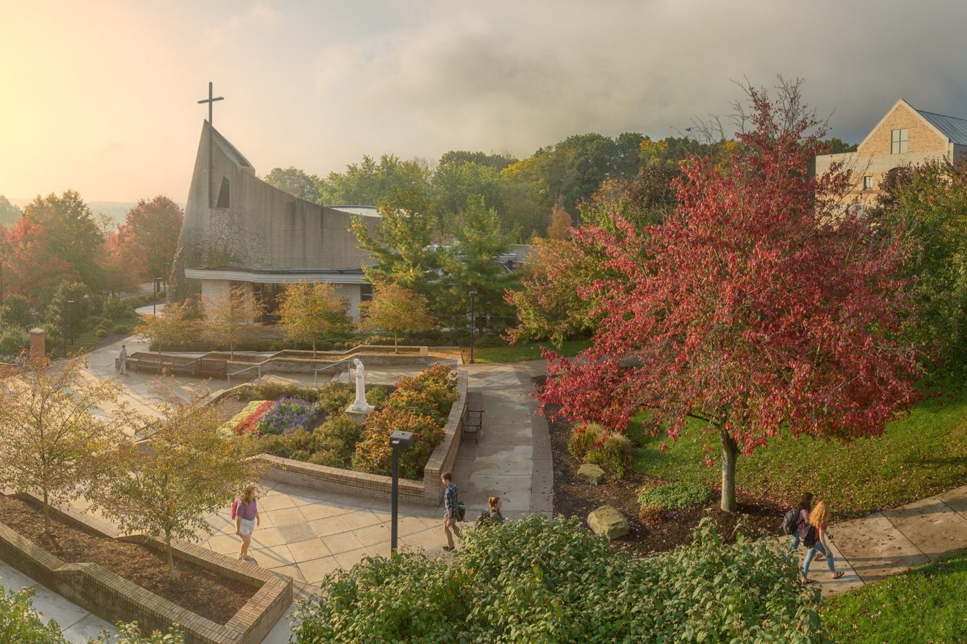A university chapel on a wooded campus at first light